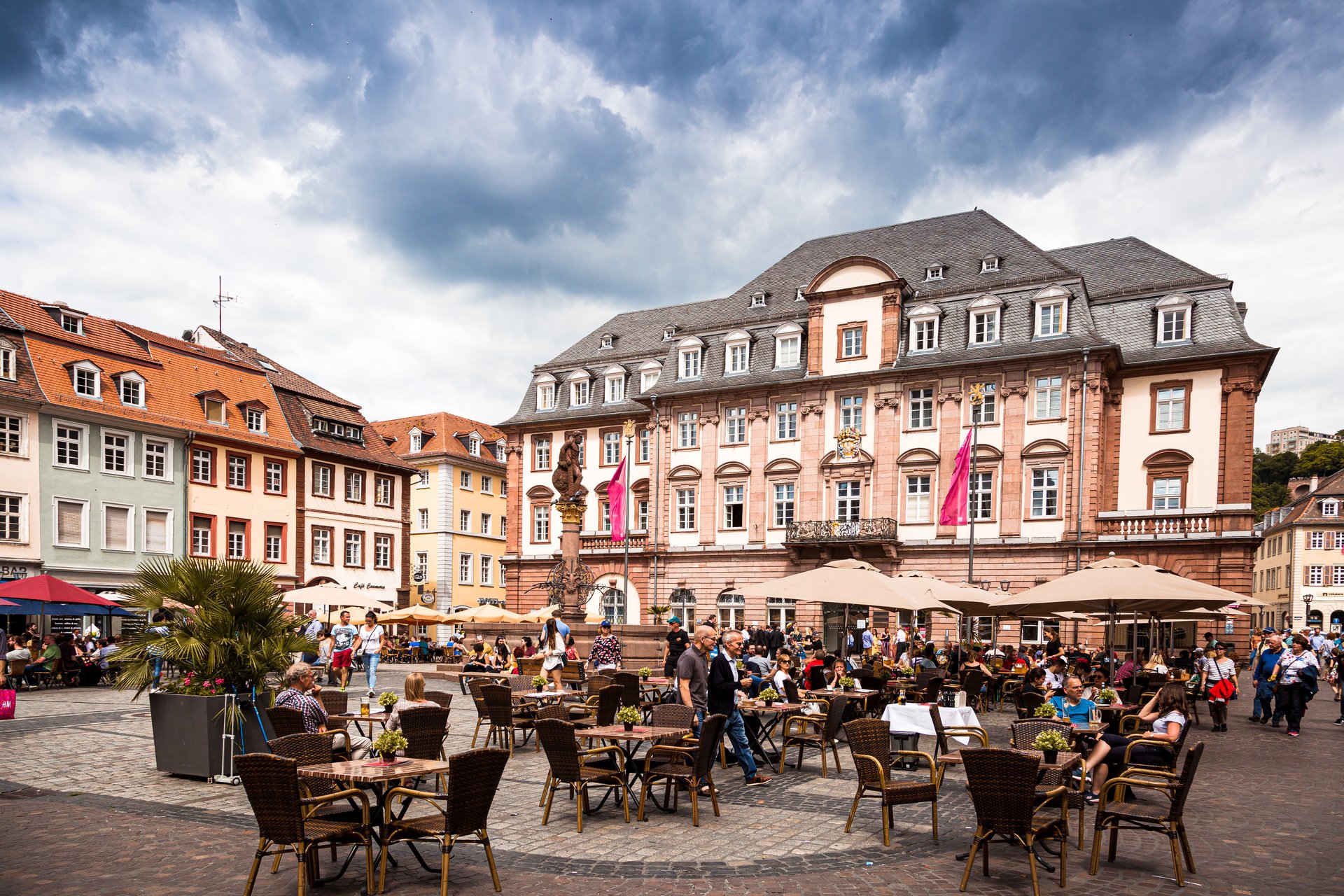 Heidelberg city square with people and outdoor cafes